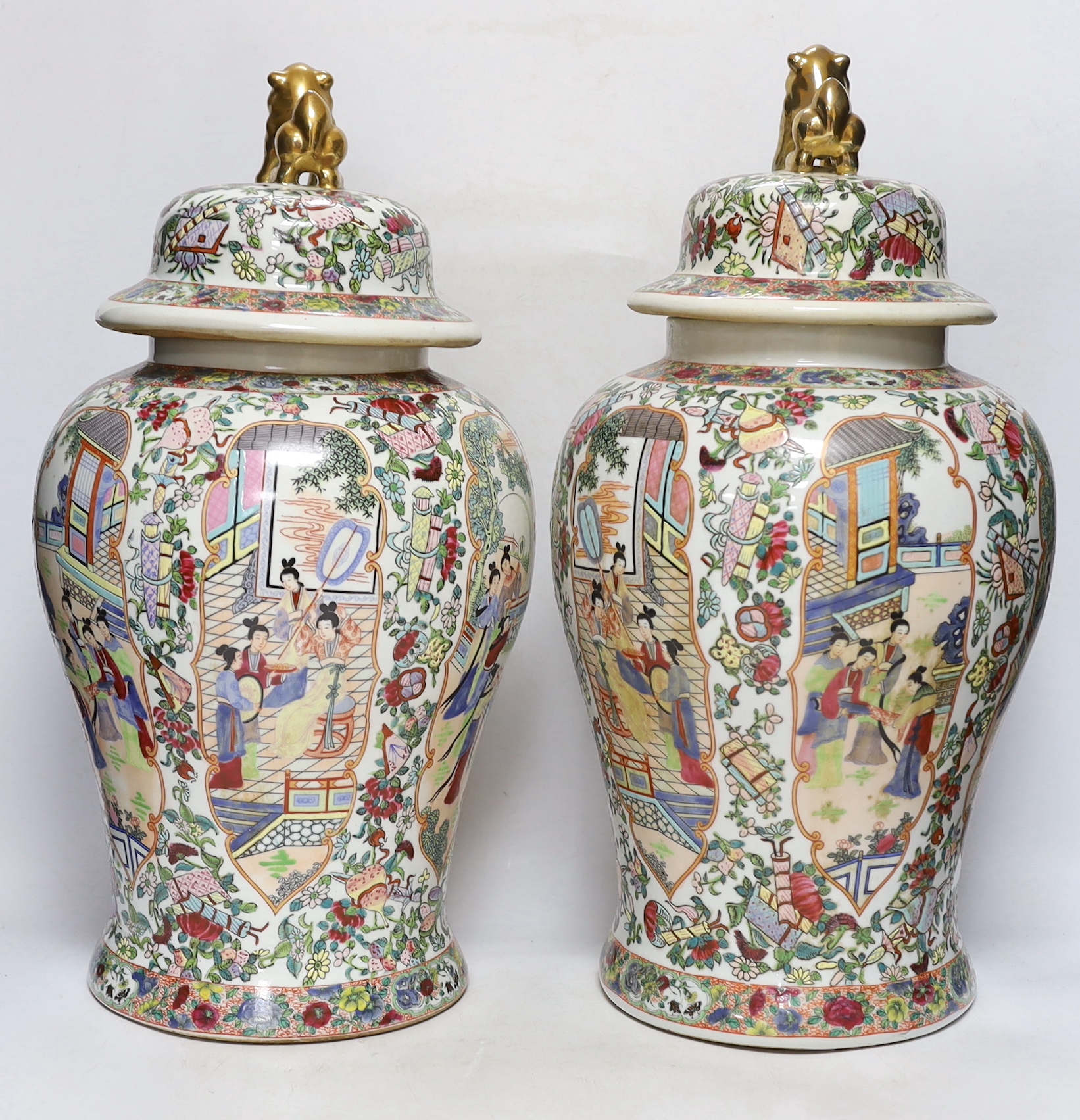 A pair of Chinese famille rose lidded vases, 49cm high
